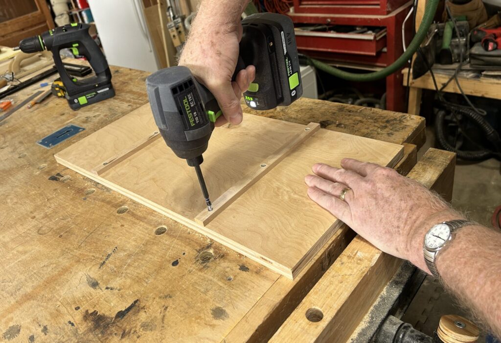 Screw the miter slot runners onto the sled